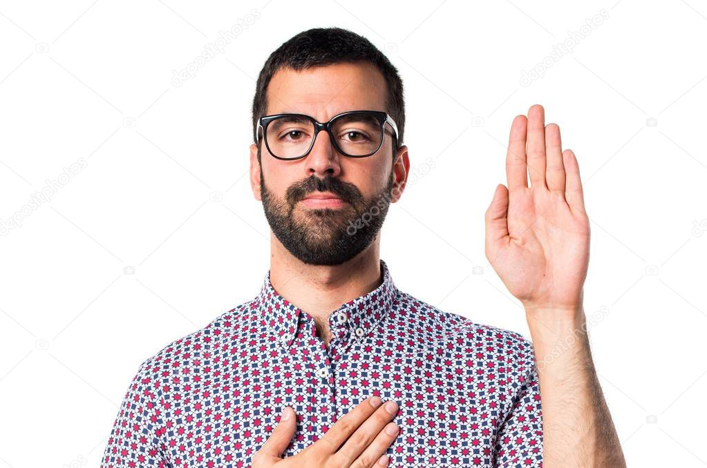 Man with glasses doing an oath