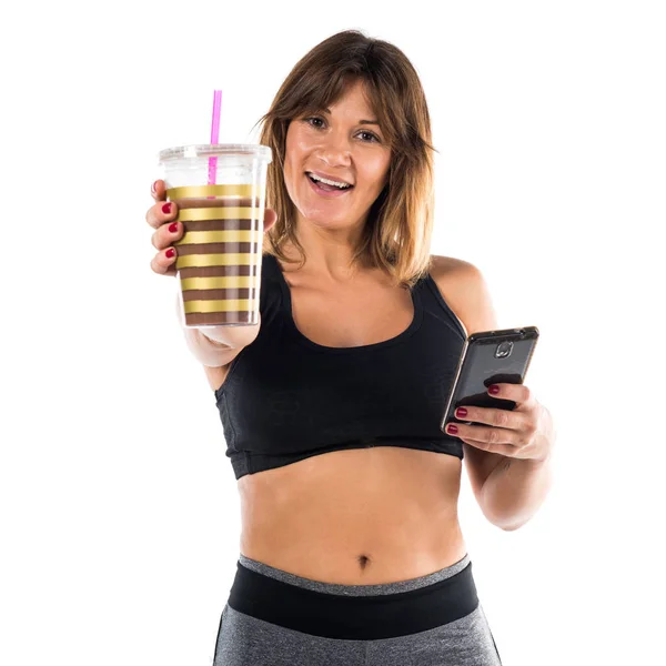 Sport woman with her mobile and her sport drink — Stock Photo, Image