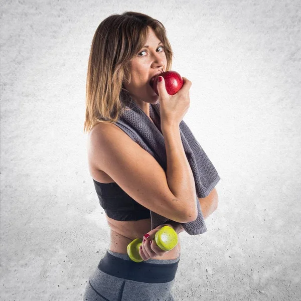 Sport woman eating an apple