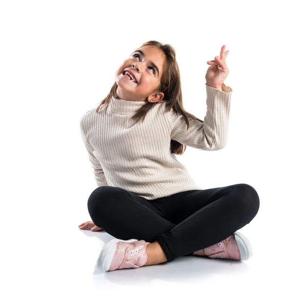 Little brunette girl pointing up — Stock Photo, Image