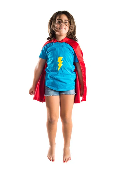 Cute little girl dressed like superhero and jumping — Stock Photo, Image