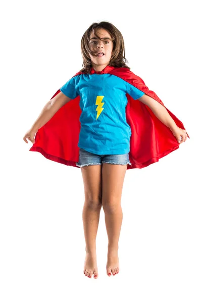 Linda niña vestida como superhéroe y saltando —  Fotos de Stock