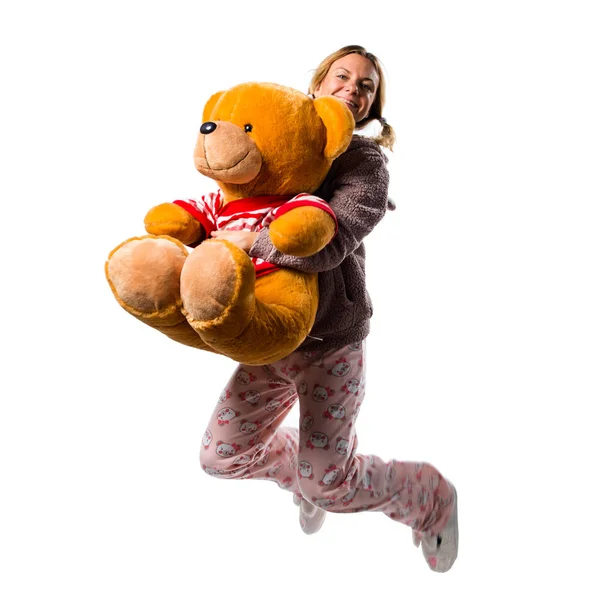 Pretty blonde girl in cute pajamas with big stuffed animal jumpi — Stock Photo, Image
