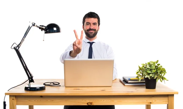 Affärsman i hans kontor räknar två — Stockfoto