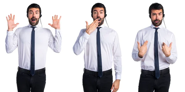 Handsome telemarketer man doing surprise gesture — Stock Photo, Image