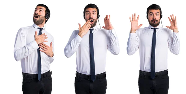 Handsome telemarketer man doing surprise gesture — Stock Photo, Image