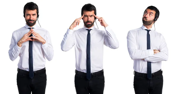 Young man with a headset thinking — Stock Photo, Image