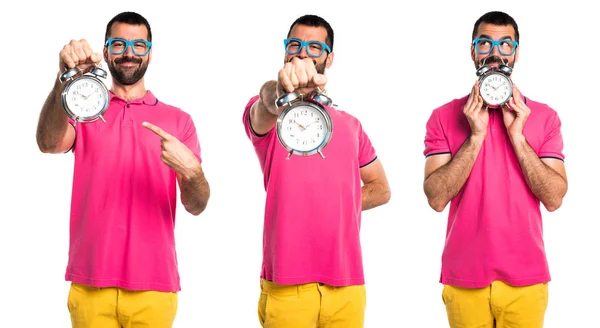 Man with colorful clothes holding vintage clock — Stock Photo, Image