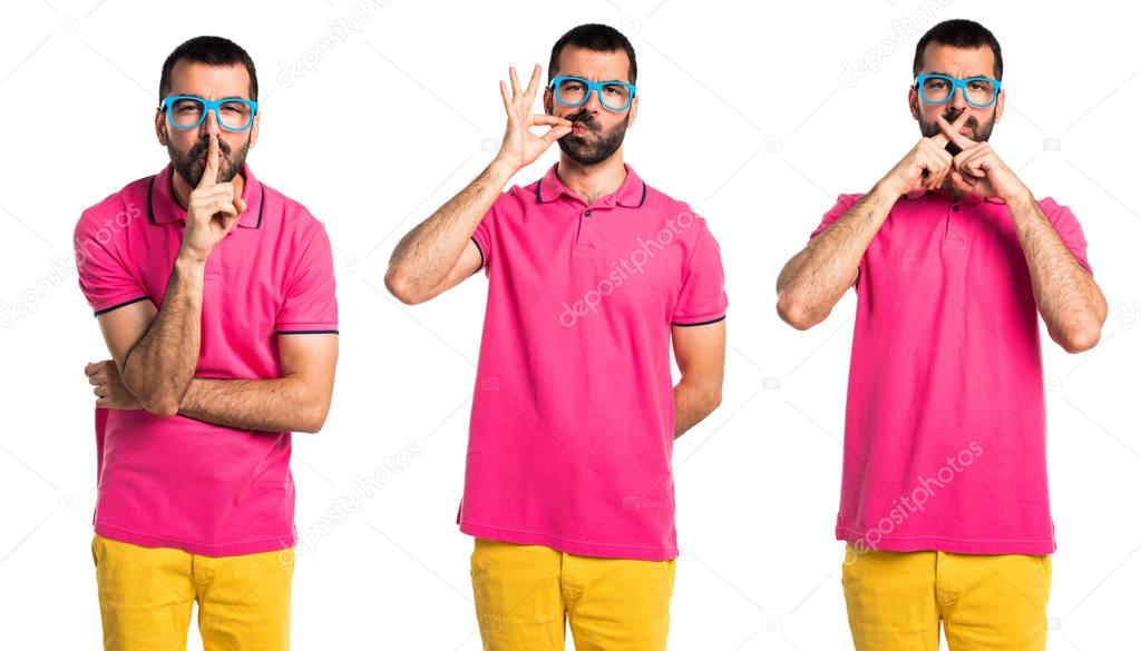 Man with colorful clothes making silence gesture