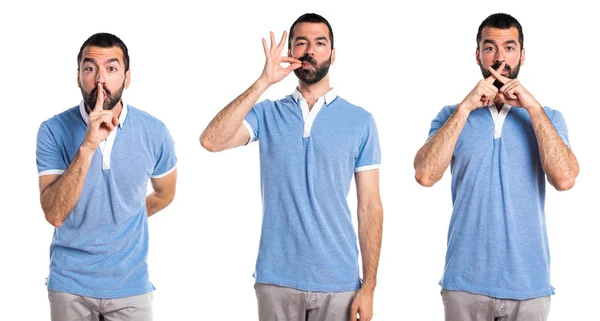 Hombre con camisa azul haciendo gesto de silencio —  Fotos de Stock