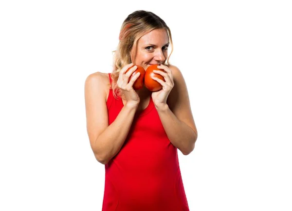 Beautiful blonde woman holding tomatoes — Stock Photo, Image