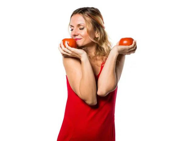 Beautiful blonde woman holding tomatoes — Stock Photo, Image