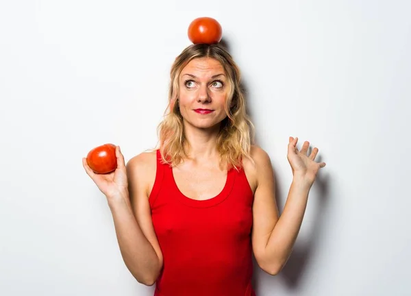 Schöne blonde Frau, die Tomaten hält — Stockfoto