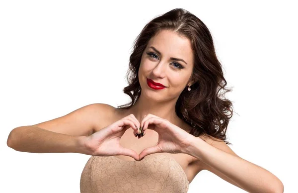Pretty young girl making a heart with her hands — Stock Photo, Image