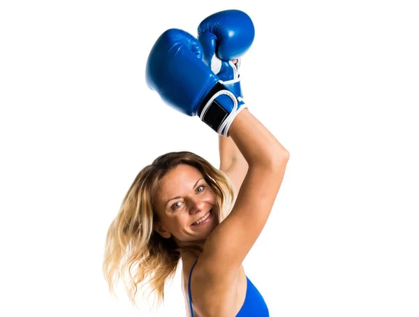 Pretty blonde woman with blue boxing gloves jumping — Stock Photo, Image
