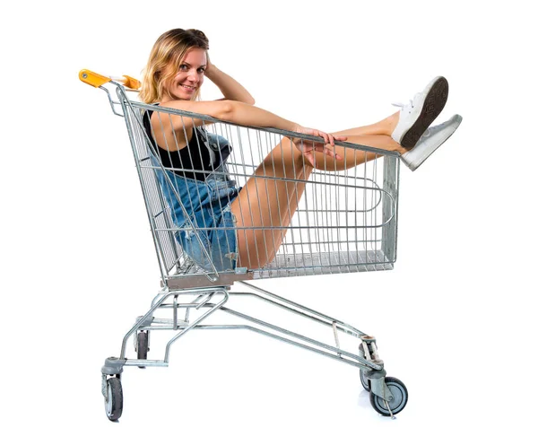 Pretty woman inside a supermarket cart — Stock Photo, Image