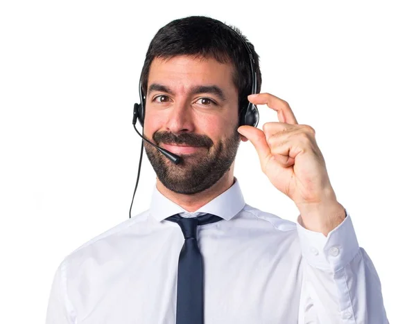 Young man with a headset doing tiny sign — Stock Photo, Image