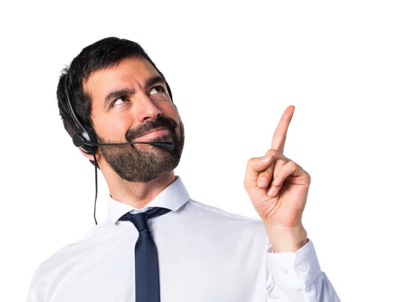 Young man with a headset pointing up — Stock Photo, Image