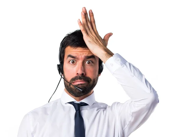 Young man with a headset having doubts — Stock Photo, Image