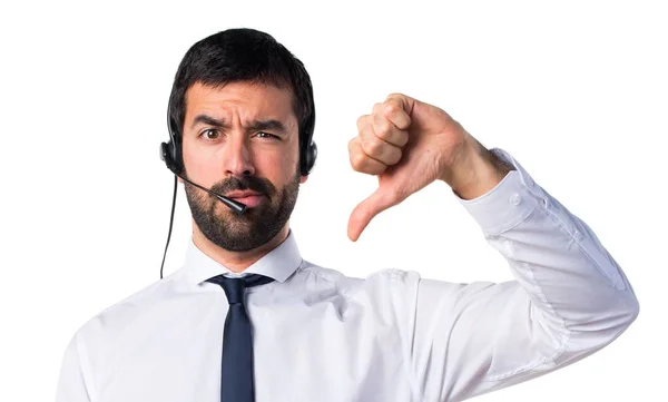 Young man with a headset doing bad signal — Stock Photo, Image