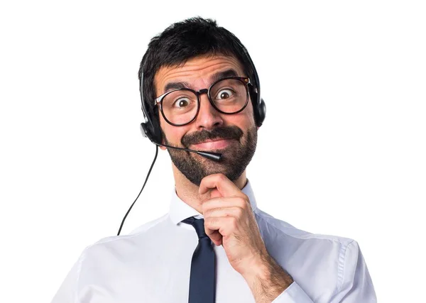 Young man with a headset thinking — Stock Photo, Image