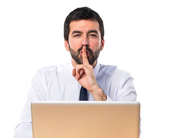 Businessman in his office making silence gesture — Stock Photo, Image