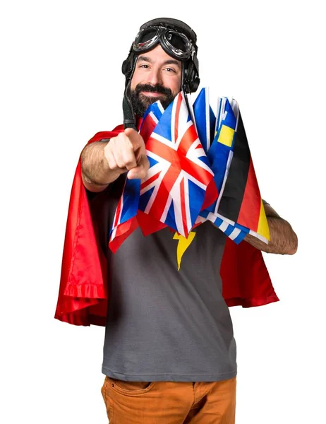 Superbohater z dużą ilością flagi wskazujące do przodu — Zdjęcie stockowe