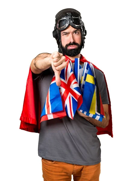 Superhero with a lot of flags making bad signal — Stock Photo, Image