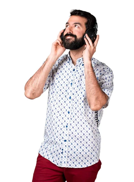 Handsome brunette man with beard listening music — Stock Photo, Image