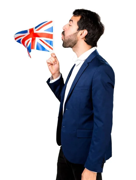 Handsome man holding an UK flag — Stock Photo, Image