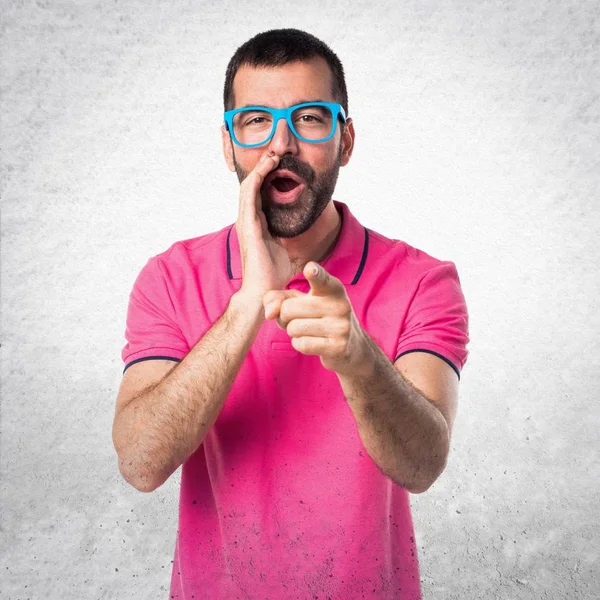 Man with colorful clothes shouting on grey textured background — Stock Photo, Image