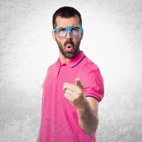 Man with colorful clothes shouting on grey textured background Royalty Free Stock Photos