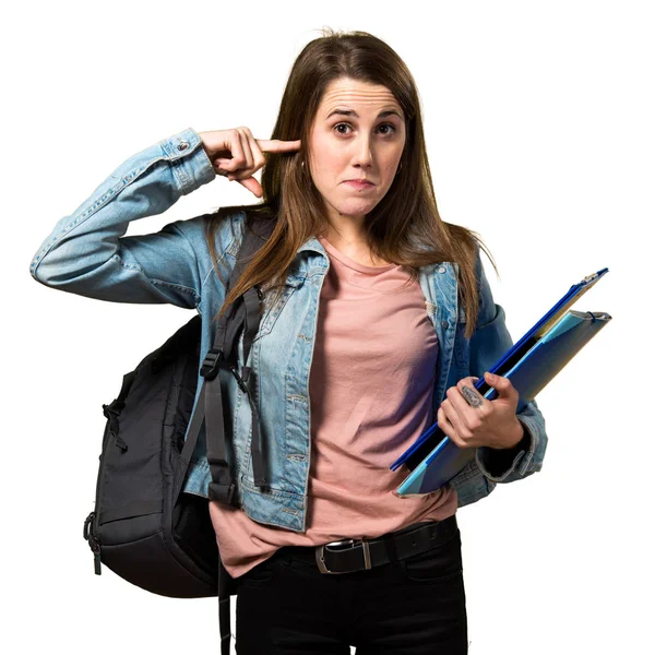 Adolescente estudiante chica sosteniendo libros y cubriendo sus oídos —  Fotos de Stock