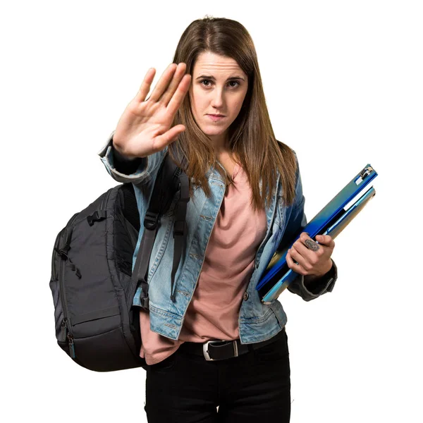 Genç öğrenci kız kitap tutan ve dur işareti yapmak — Stok fotoğraf