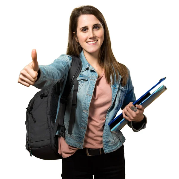 Teen student girl holding books and with thumb up — Stock Photo, Image