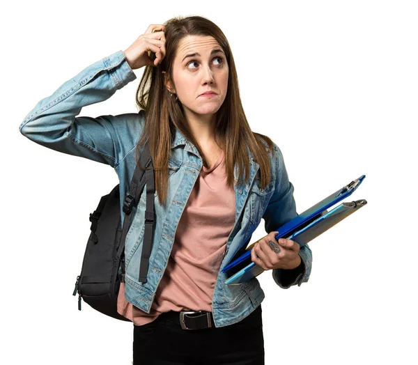 Teen student girl holding books and having doubts — Stock Photo, Image