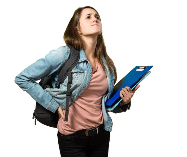 Adolescente estudiante chica sosteniendo libros y con dolor de espalda —  Fotos de Stock