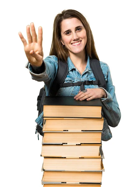 Teen student girl with a lot of books and counting four — Stock Photo, Image