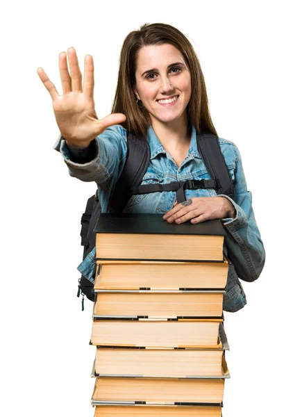 Teen student girl with a lot of books and counting five — Stock Photo, Image