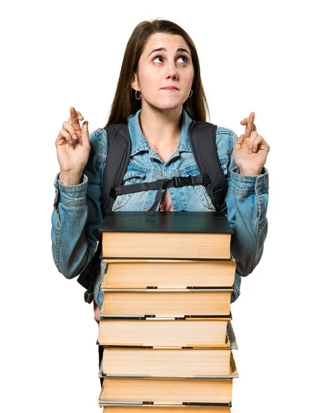 Adolescente estudiante chica con un montón de libros y con los dedos cruzados — Foto de Stock