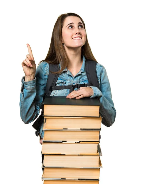 Tiener student meisje met een heleboel boeken en omhoog — Stockfoto