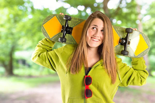 Skater with green sweatshirt over white background — Stock Photo, Image