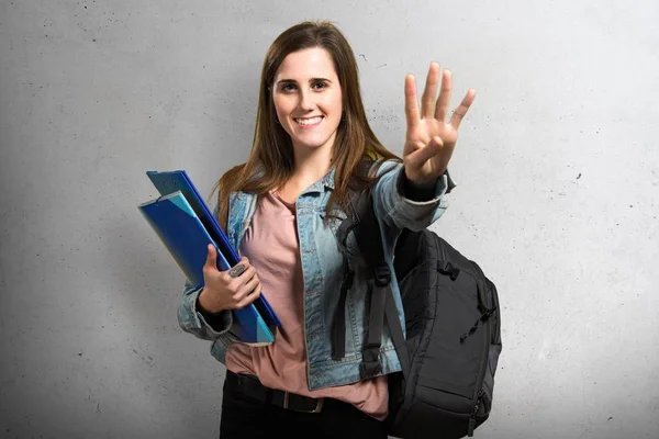 Teenager Schülerin hält Bücher in der Hand und zählt vier — Stockfoto