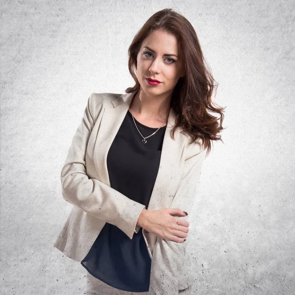 Beautiful brunette girl posing in studio on textured grey backgr — Stock Photo, Image