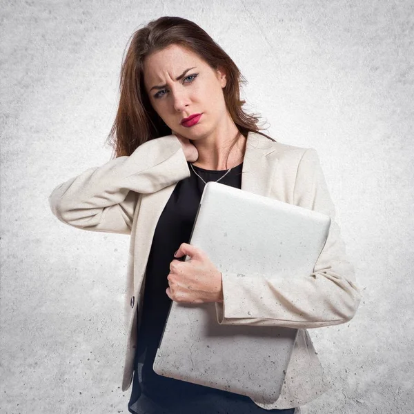 Mooie jonge zakenvrouw met laptop en nekpijn op te — Stockfoto