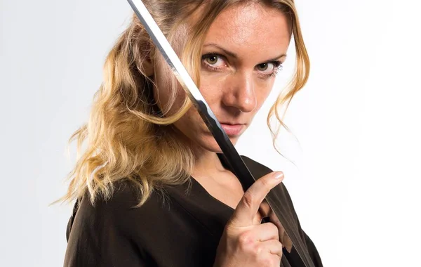 Blonde woman dressed like samurai with a katana — Stock Photo, Image