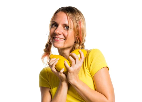 Beautiful blonde woman holding lemons — Stock Photo, Image