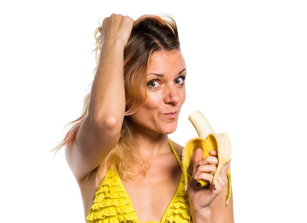 Beautiful blonde woman in bikini holding bananas — Stock Photo, Image