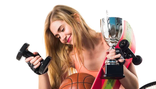 Menina do esporte com um monte de itens esportivos — Fotografia de Stock