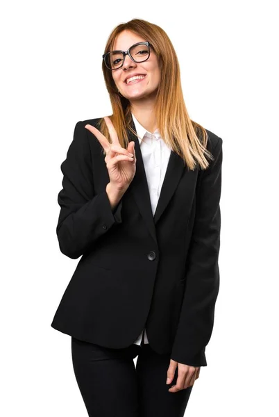 Young business woman making victory gesture — Stock Photo, Image